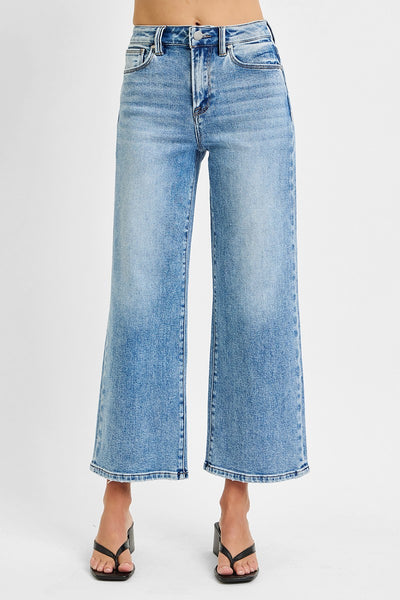 Blue jeans worn by a person on a white background