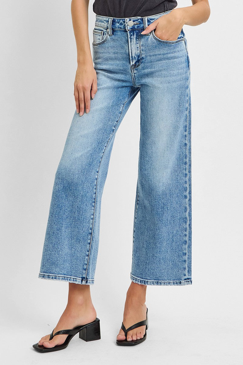 Person wearing light blue jeans on a white background
