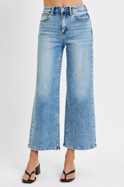 Blue jeans worn by a person on a white background