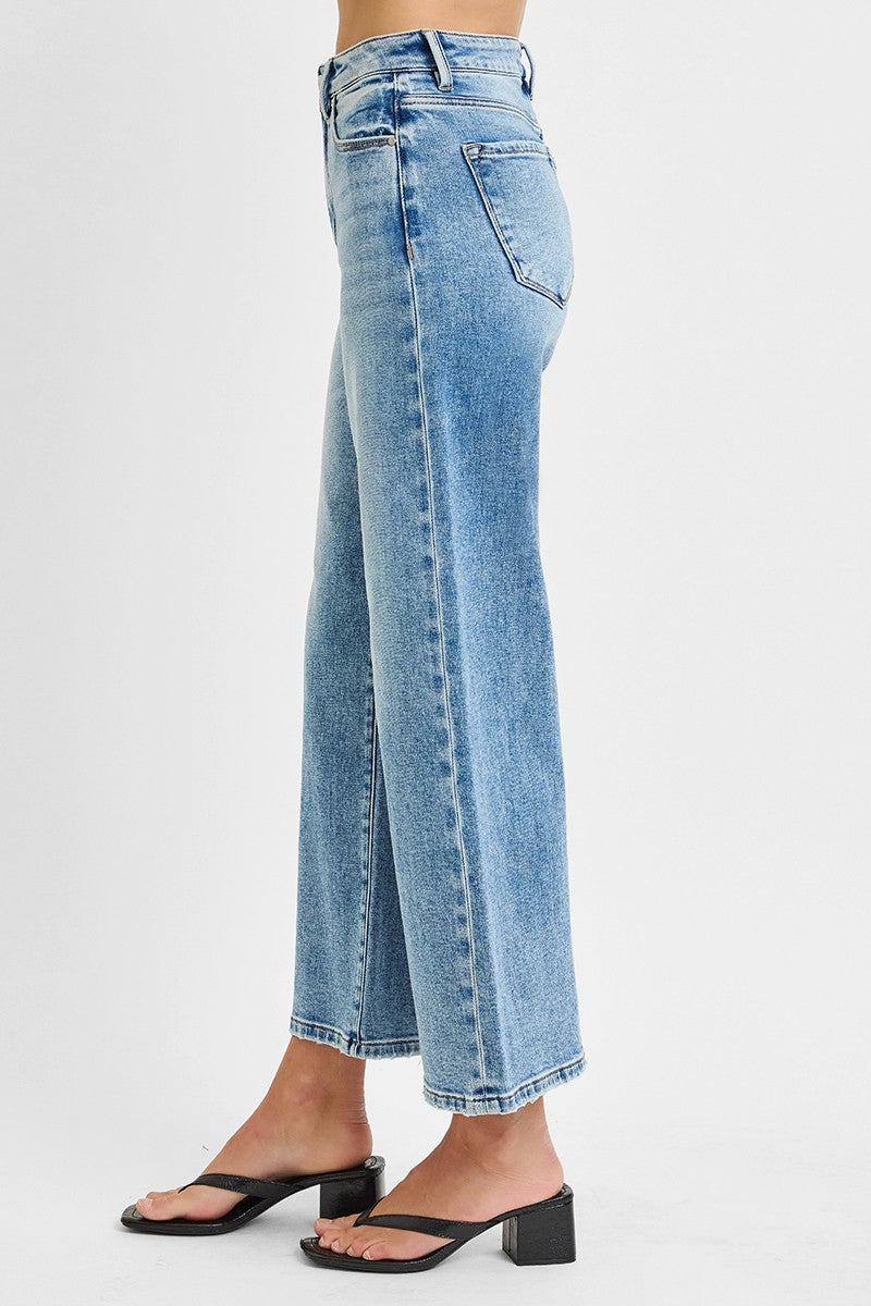 Light blue jeans worn by a person on a white background