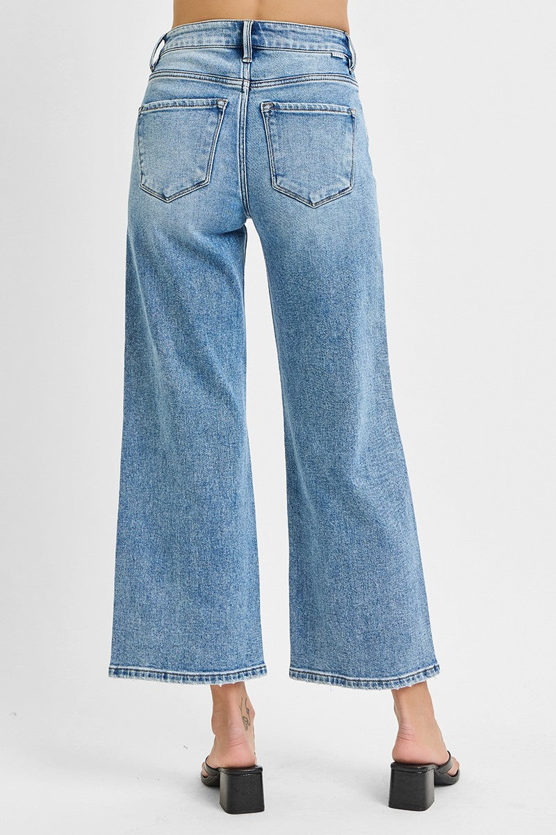 Light blue jeans worn by a person on a white background