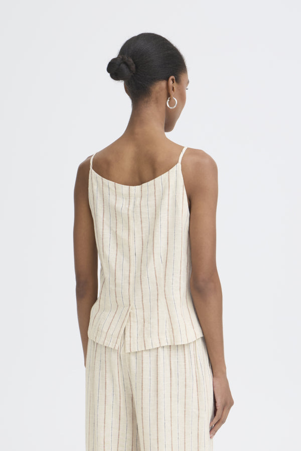 Woman wearing a white pinstripe dress on a light gray background