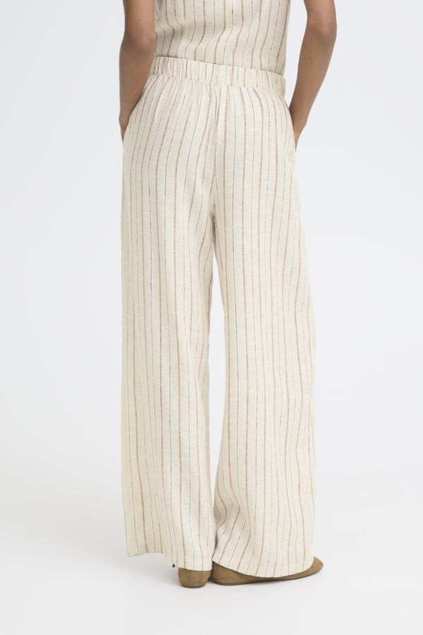 Person wearing a white outfit with vertical stripes on a white background
