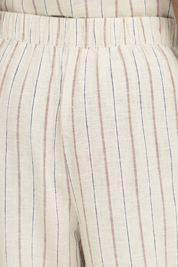 Close-up of beige pants with thin striped pattern