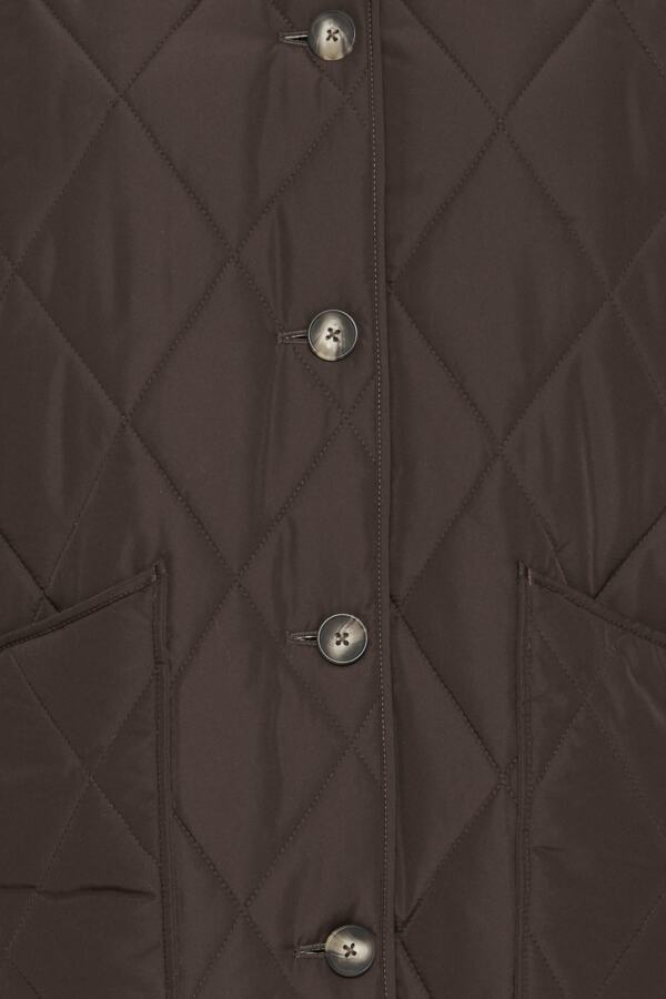 Close-up of a dark brown diamond-quilted jacket with silver buttons and side pockets.