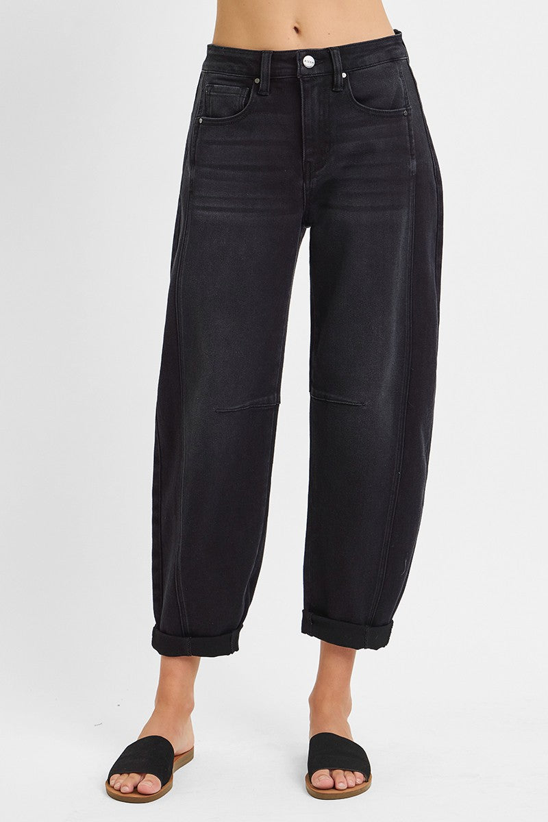 Black jeans worn by a person on a white background