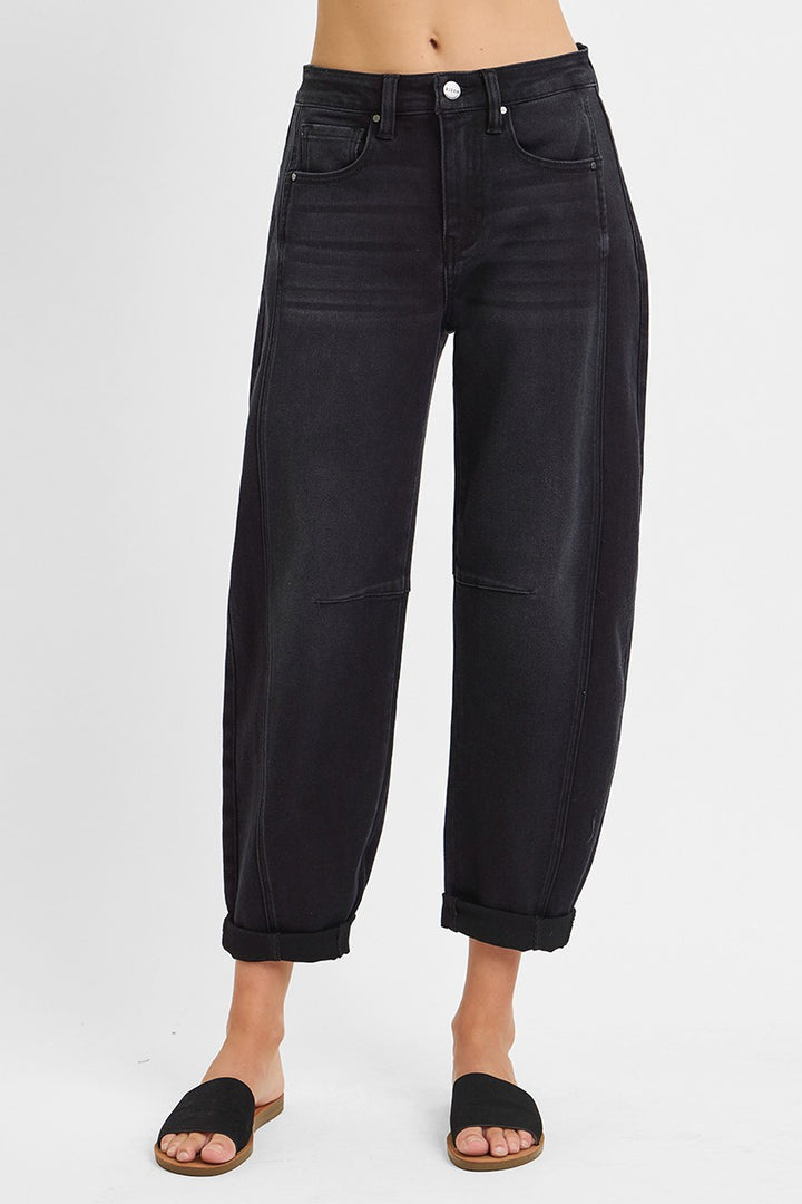 Black jeans worn by a person on a white background