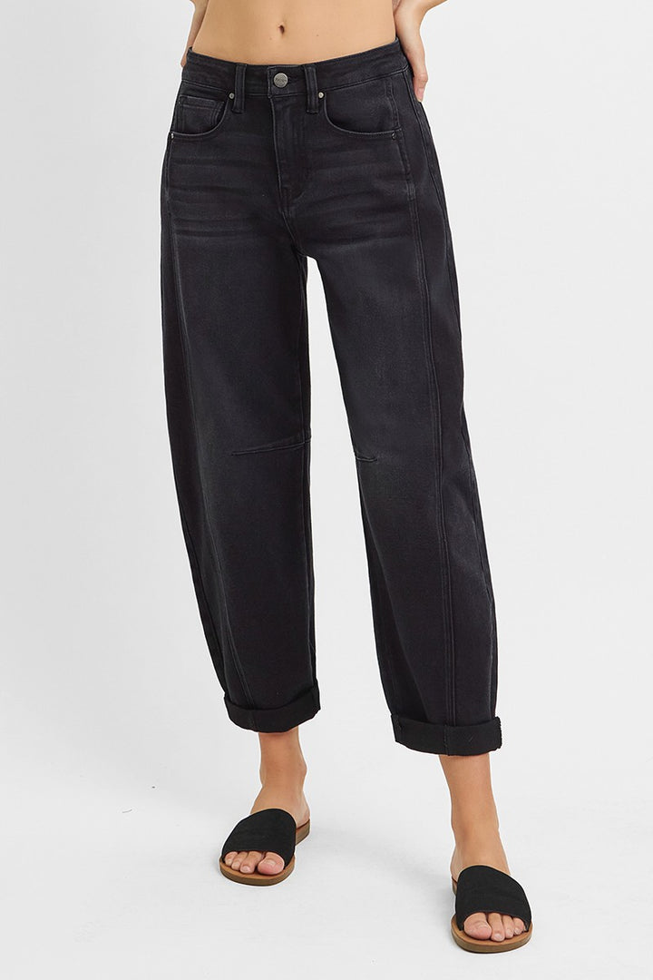 Black jeans worn by a person on a white background