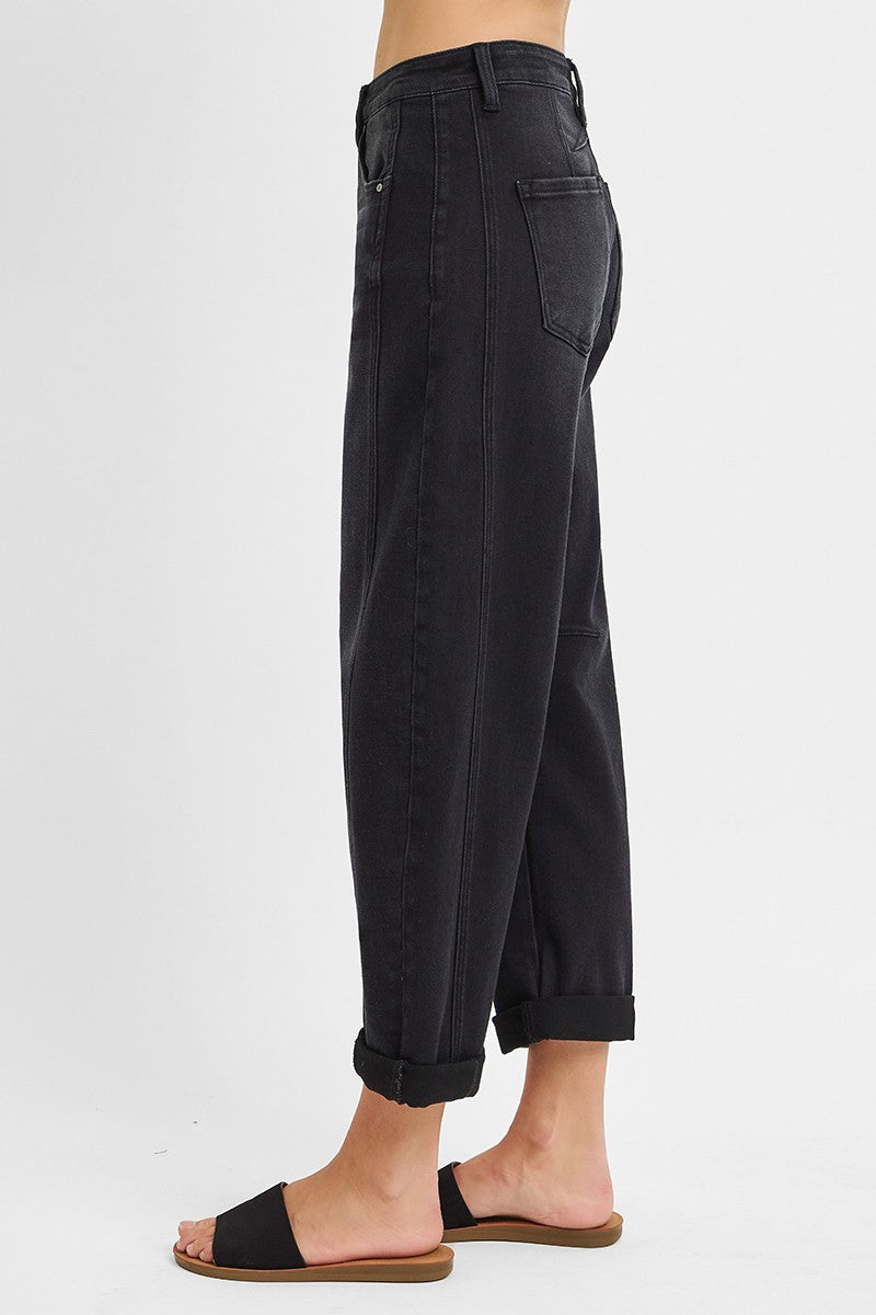 Black pants worn by a person on a white background