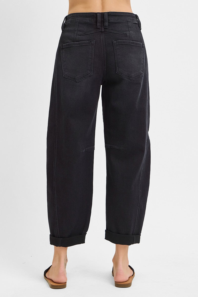 Black pants worn by a person on a white background