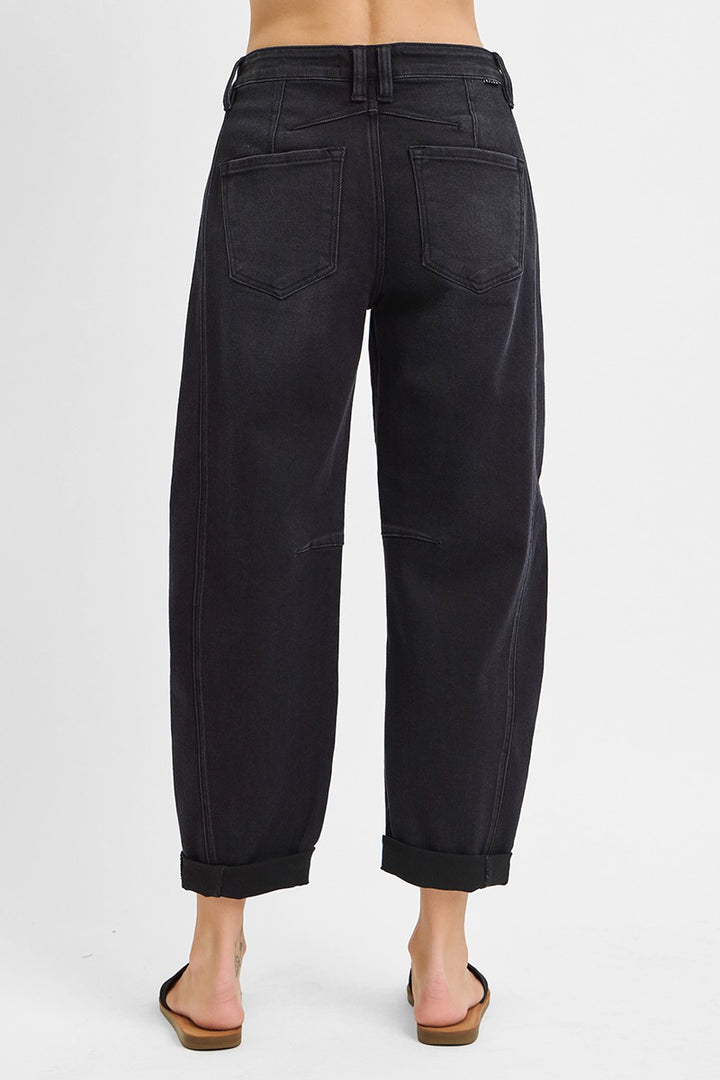 Black pants worn by a person on a white background