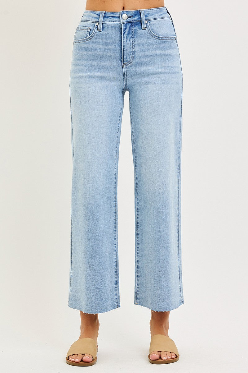 Light blue jeans worn by a person on a white background