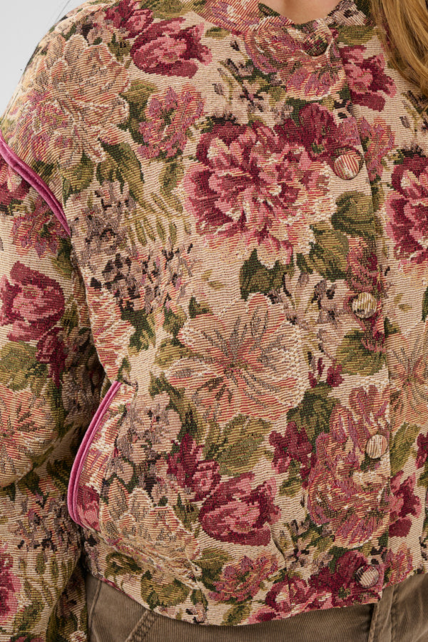 Close-up of a floral patterned jacket with pink and green colors.