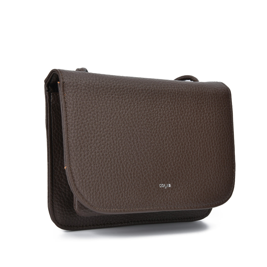 A dark brown pebbled leather shoulder bag with a small white &