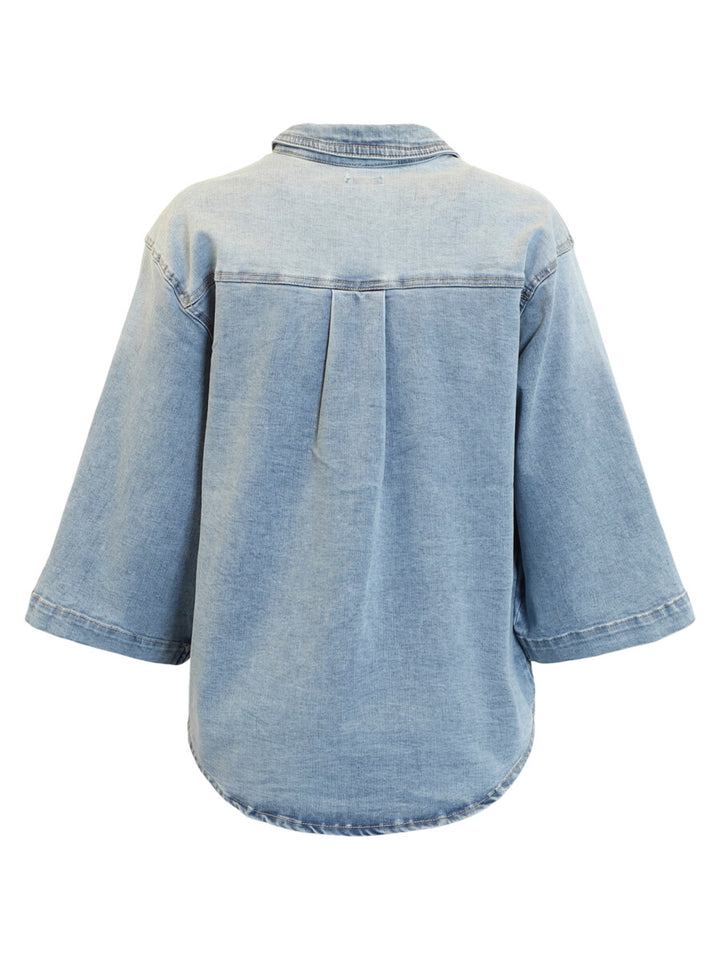 Light blue denim shirt on a white background