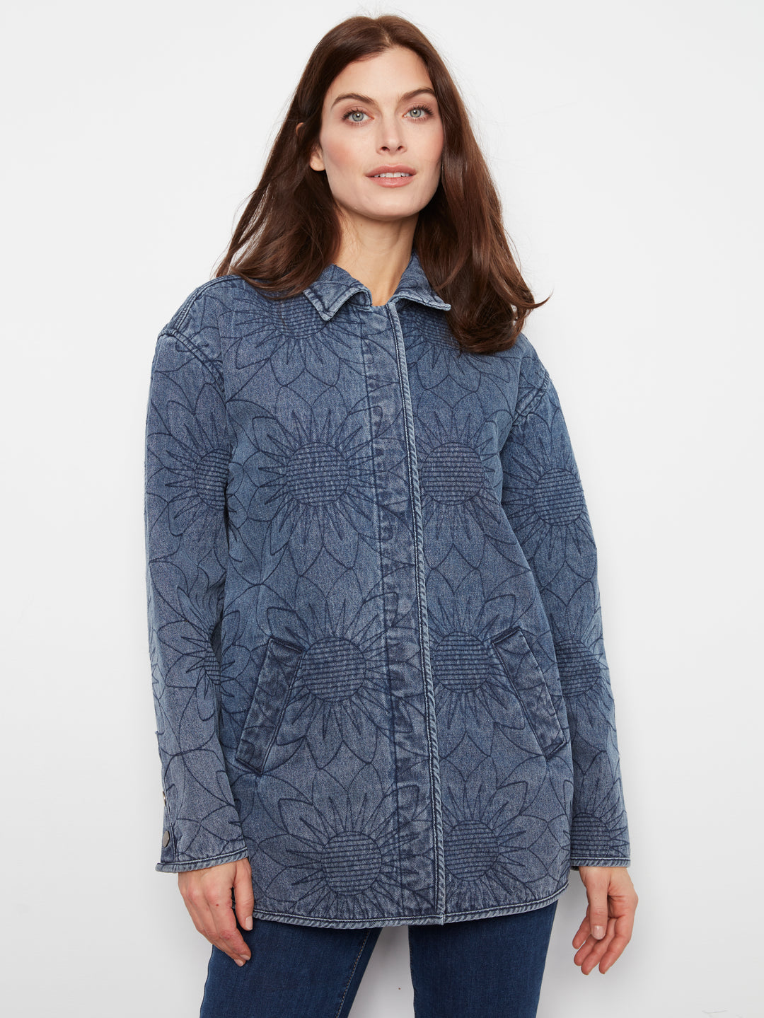 Woman wearing a blue patterned jacket on a white background