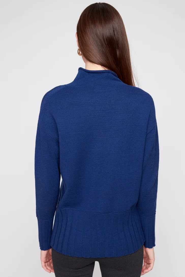 Woman wearing a blue sweater against a white background