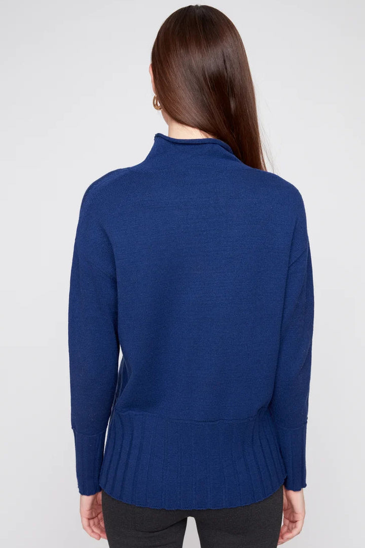 Woman wearing a blue sweater against a white background
