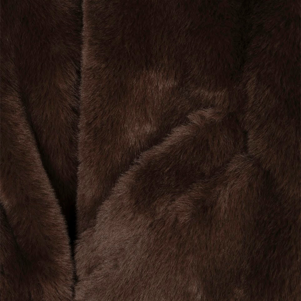 A close-up of dark brown faux fur fabric with soft, plush texture and a central seam.
