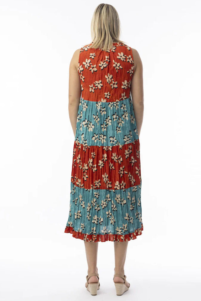 Woman wearing a red and blue floral dress on a white background