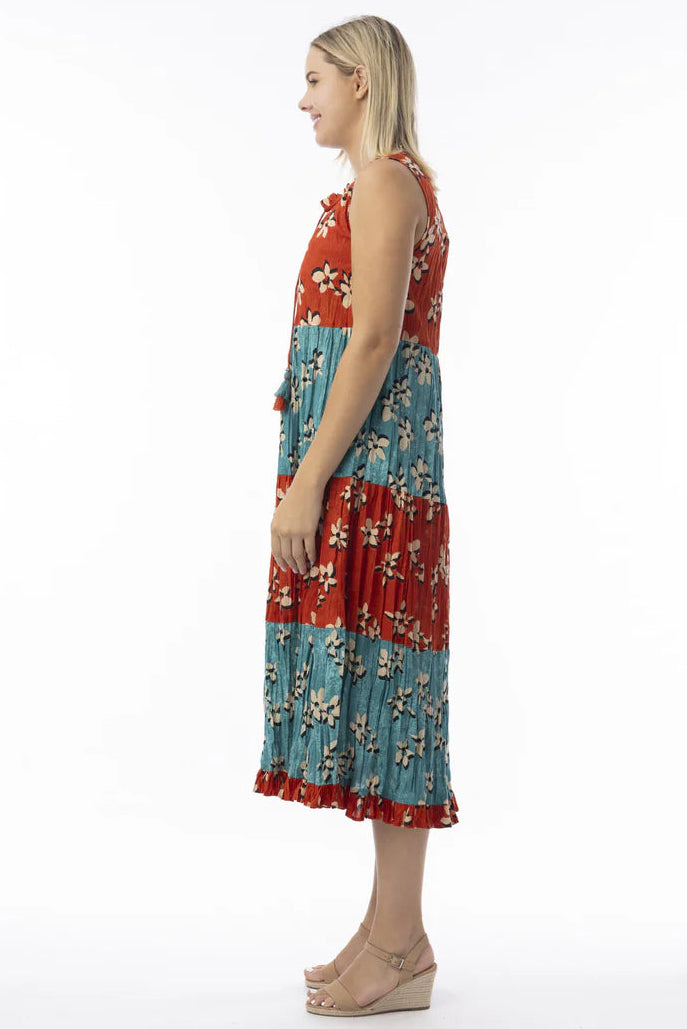 Woman wearing a red and blue floral dress on a white background