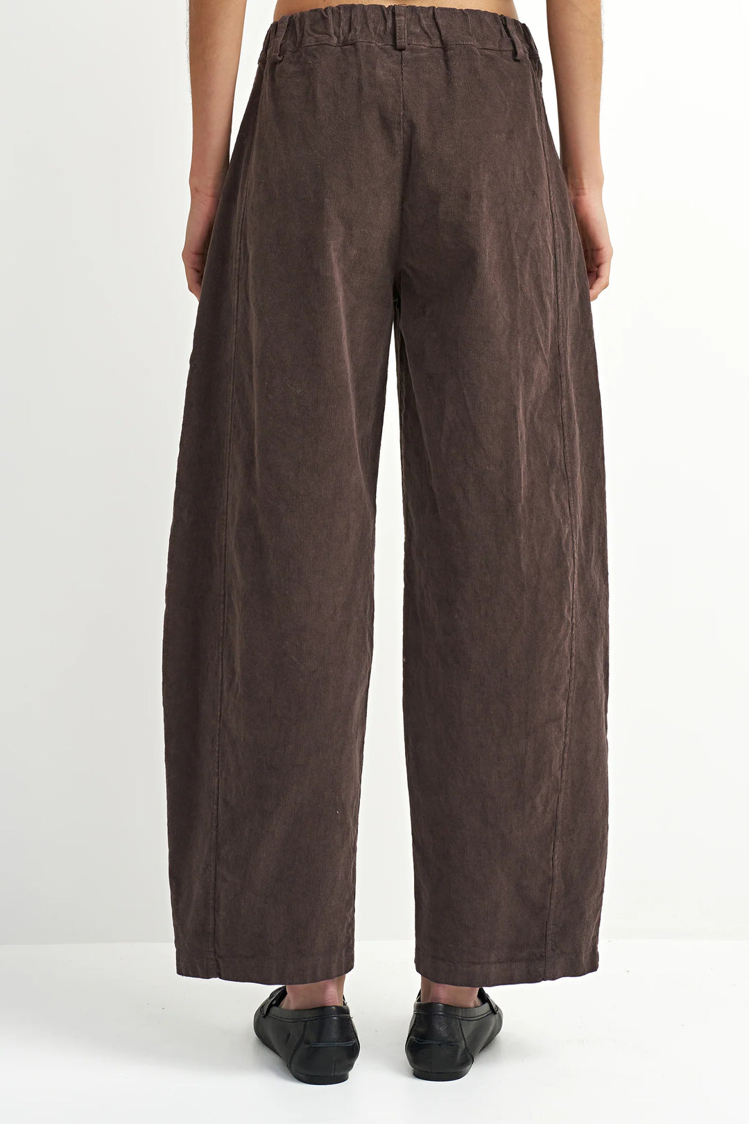 Brown wide-leg pants worn by a person on a white background