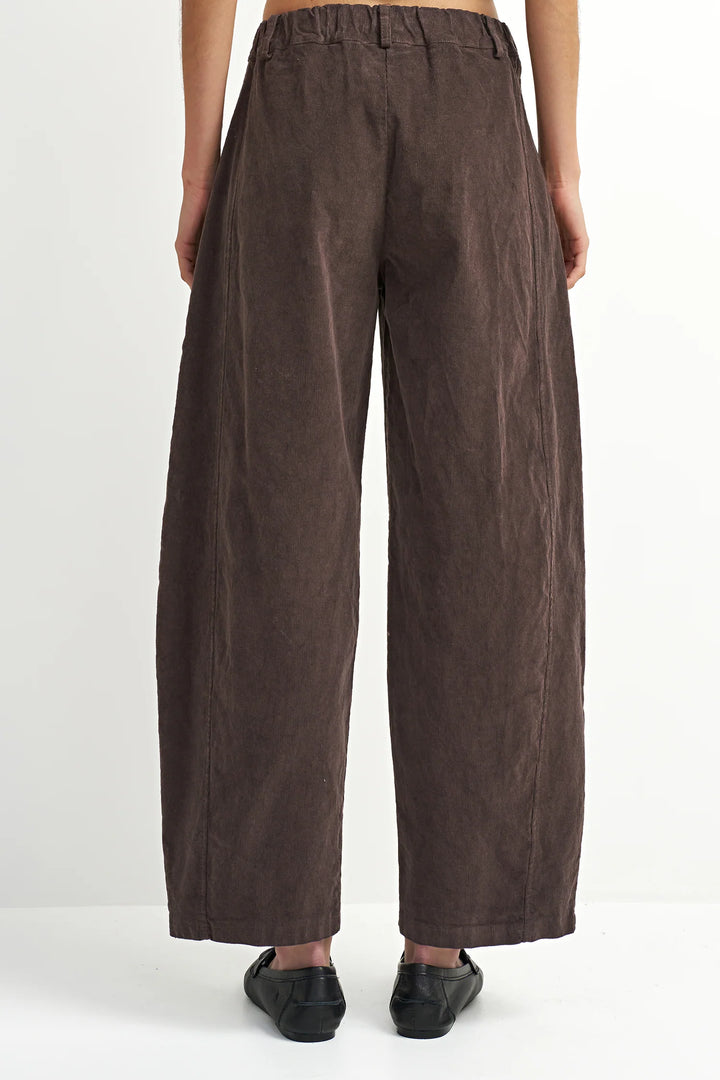 Brown wide-leg pants worn by a person on a white background