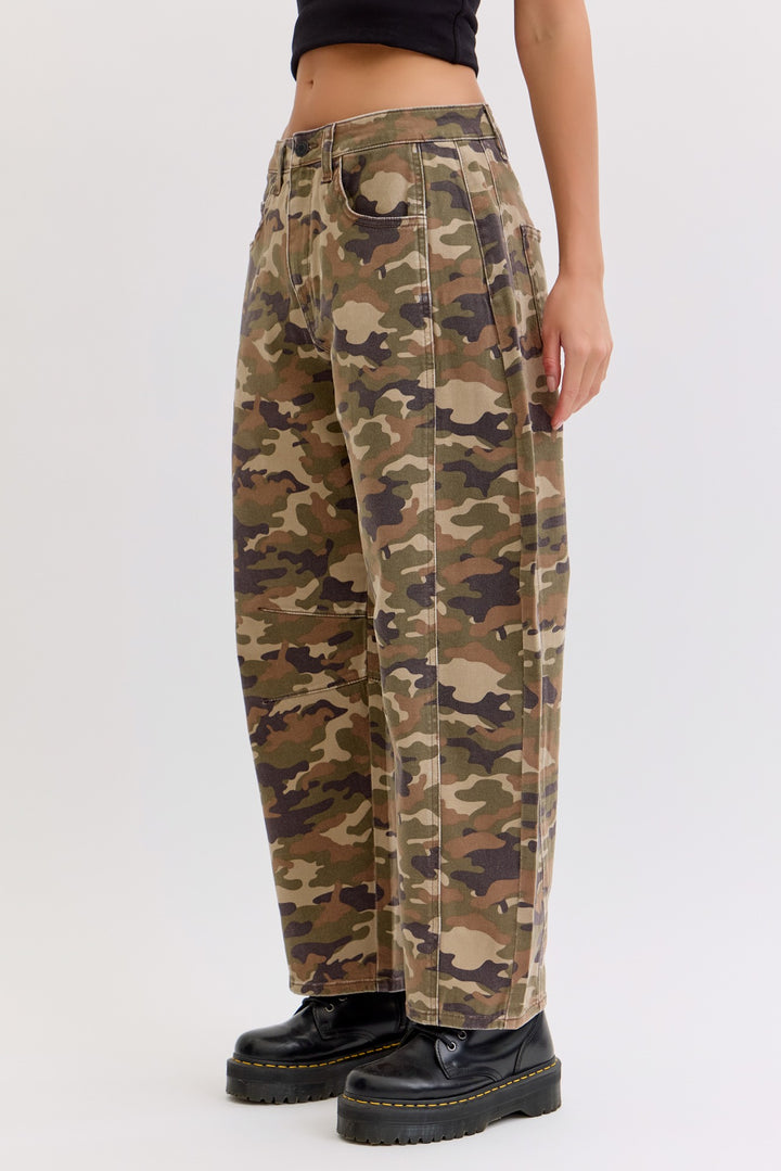 Camouflage pants worn by a person on a white background