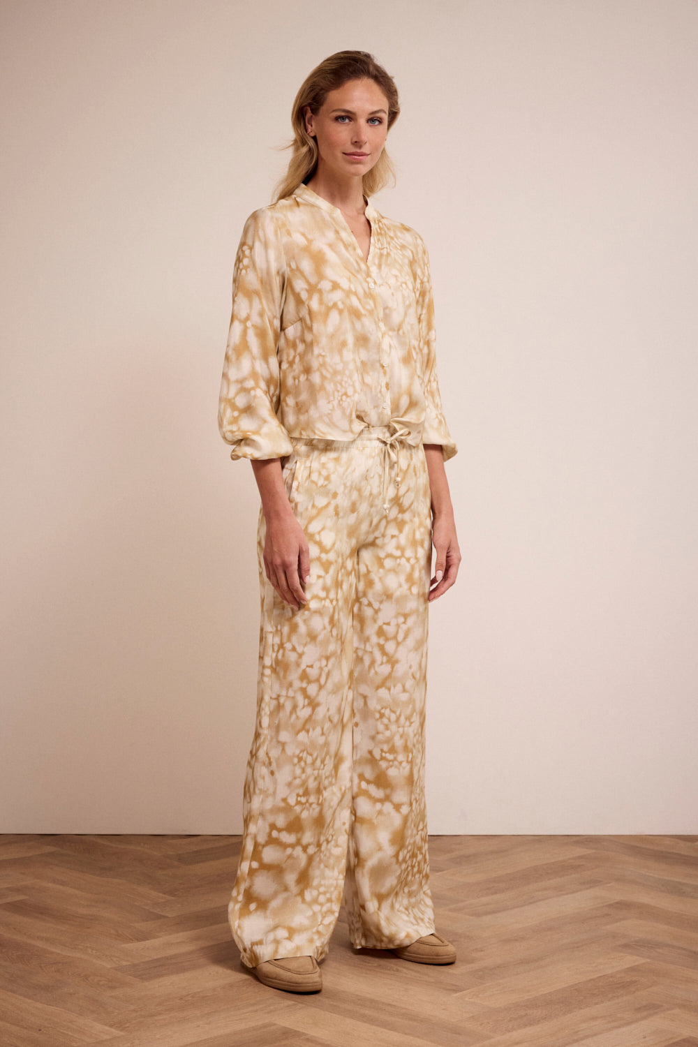 Woman wearing a floral outfit on a plain background