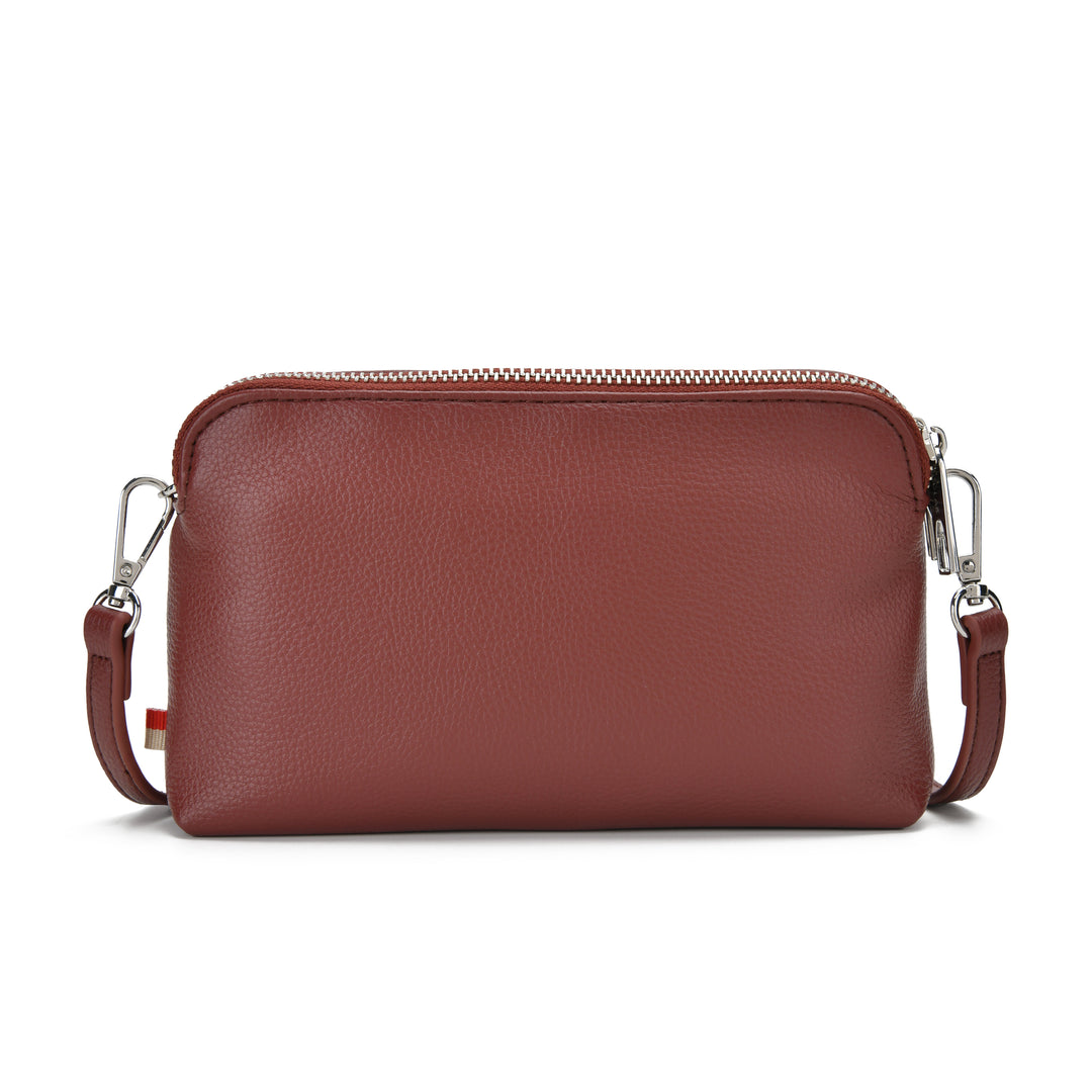 A reddish-brown pebbled leather crossbody bag with a top zipper and silver-tone hardware, shown against a plain white background.