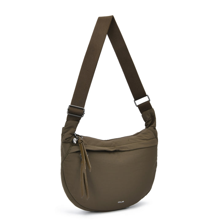 An olive green semi-circular crossbody bag with a matching adjustable shoulder strap, shown on a clean white background. The brand name &