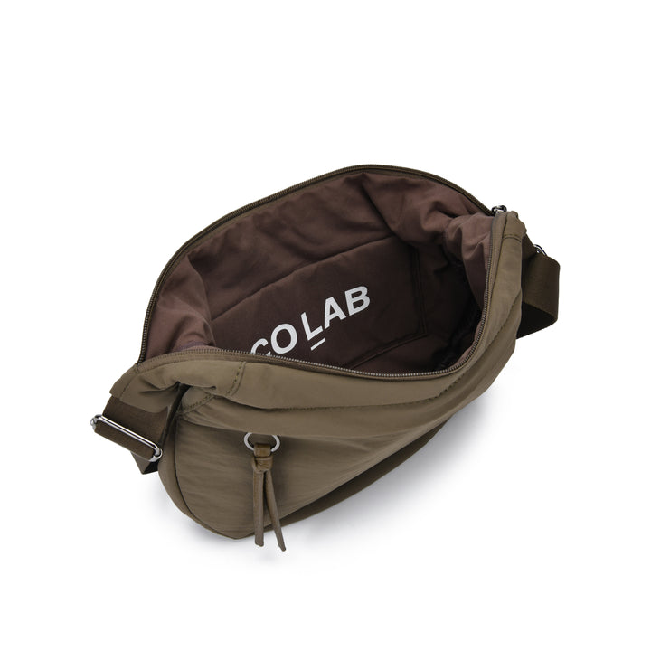 An olive green nylon crossbody bag shown from an overhead angle, open to reveal a brown interior with the brand name &