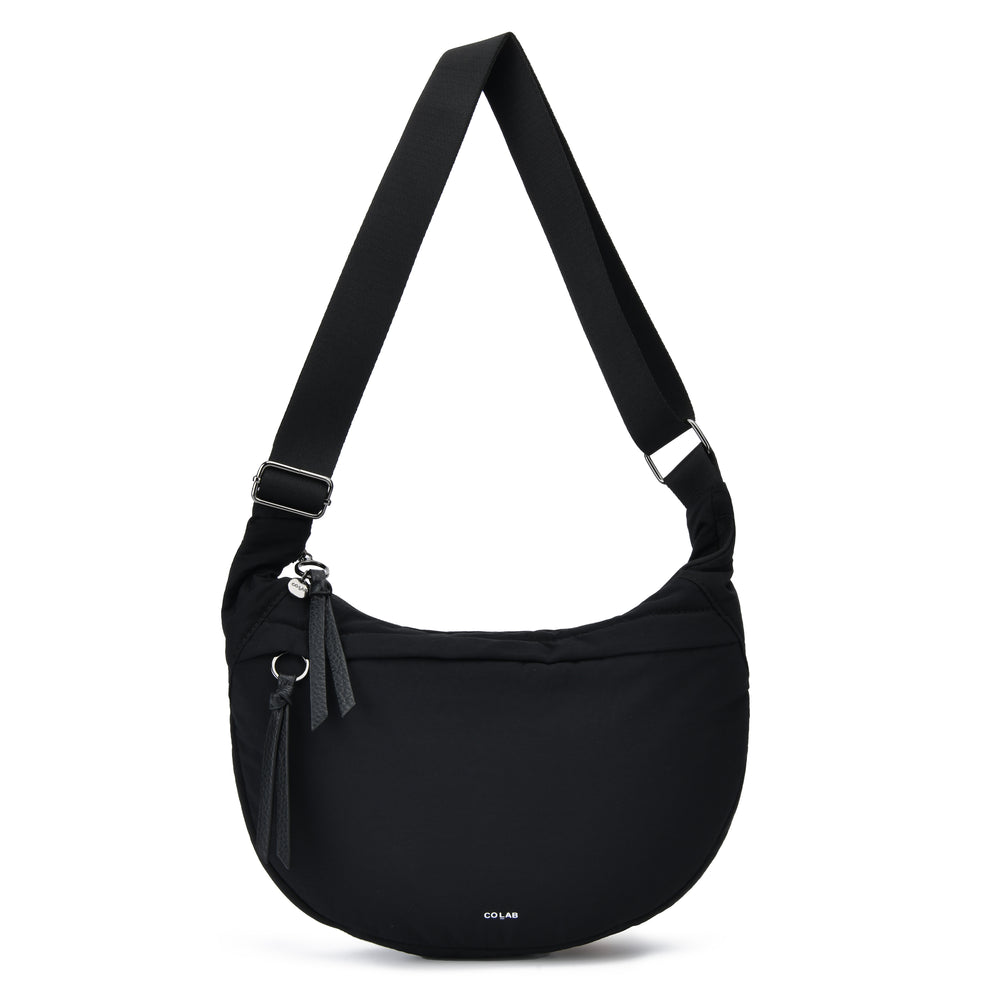 A black crescent-shaped shoulder bag with an adjustable shoulder strap, a front zippered pocket with a tassel, and a small white 'OLIVAR' logo on the bottom front, shown against a plain white background.