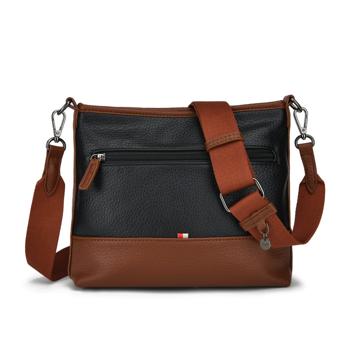 A two-tone leather crossbody bag with a black pebbled front panel and warm brown leather trim, featuring a matching brown adjustable shoulder strap with silver-tone hardware.