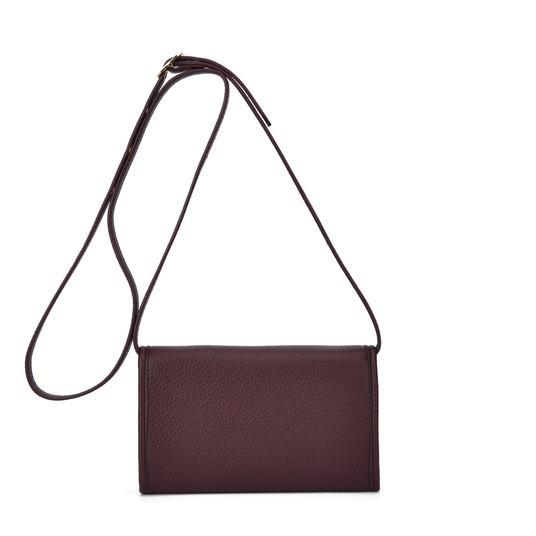 A dark burgundy pebbled leather crossbody bag with a thin matching leather strap, displayed against a solid white background.