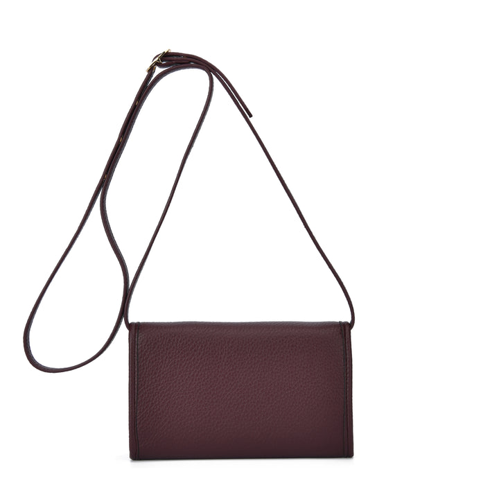 A dark burgundy pebbled leather crossbody bag with a thin matching leather strap, displayed against a solid white background.