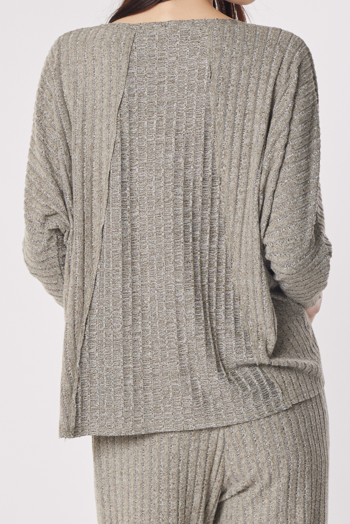 A person shown from the back wearing a ribbed knit two-piece loungewear set in a heathered taupe-gray color, featuring a long-sleeve top and matching pants against a plain light gray background.