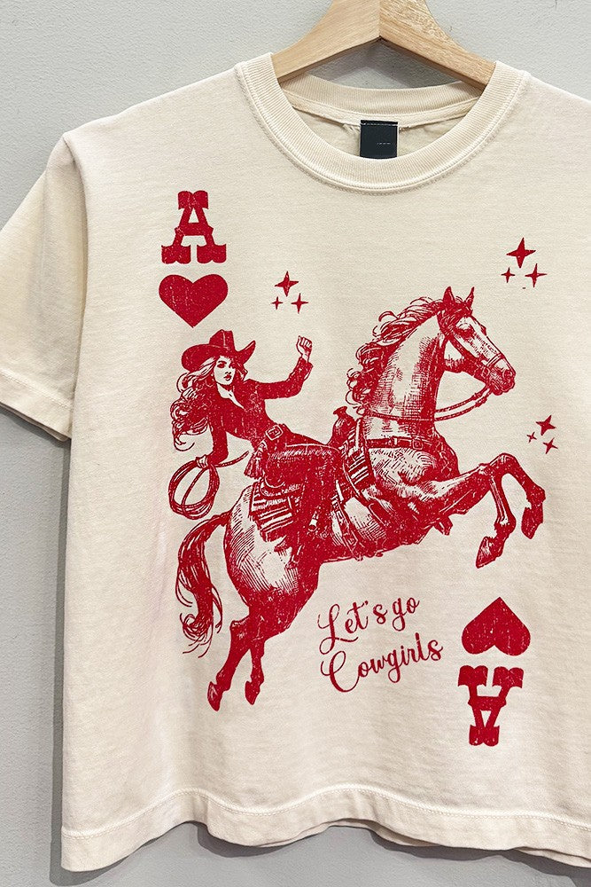 Beige t-shirt with red graphic of a cowgirl on a horse and text 'Let's go Cowgirls' on a gray background.