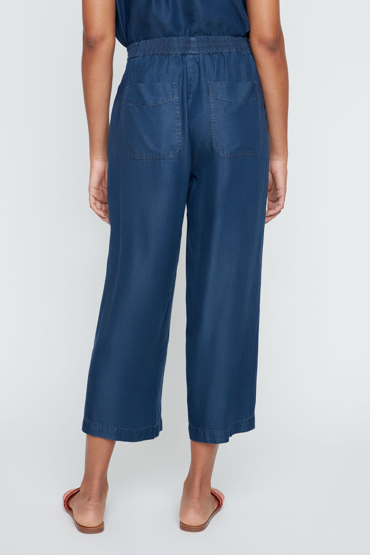 Person wearing blue pants on a white background