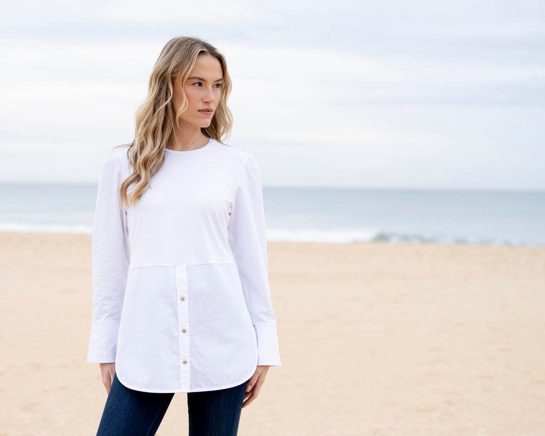 Woman wearing a white shirt on a beach