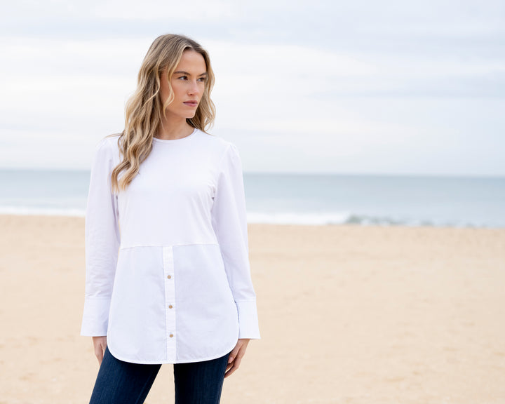 Woman wearing a white shirt on a beach