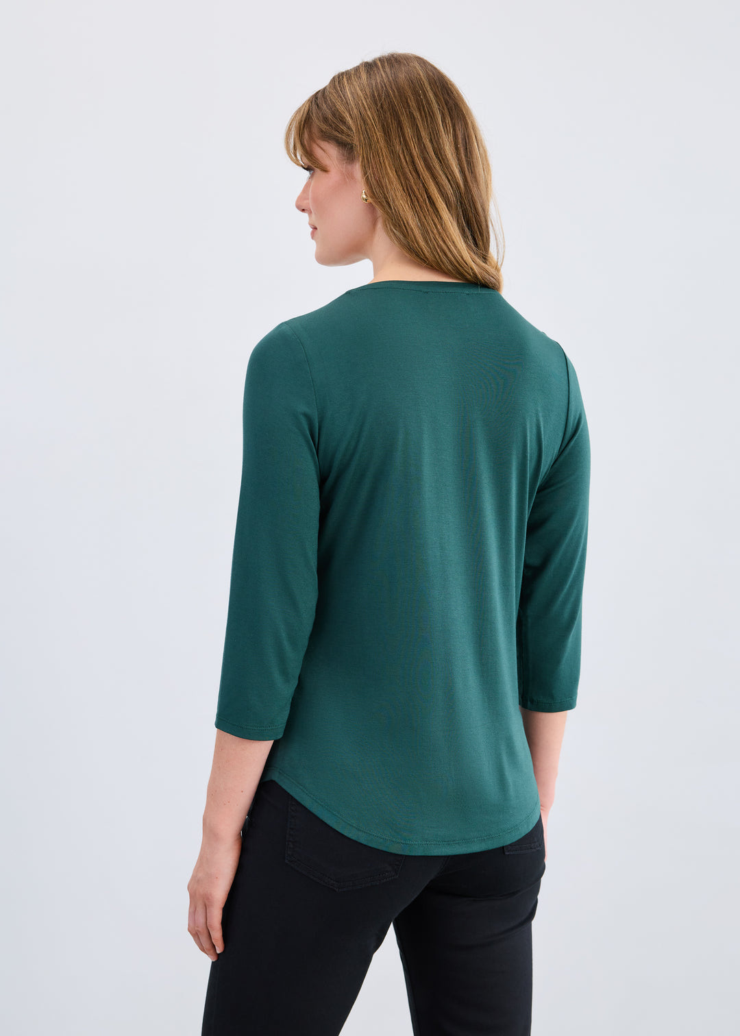 Woman wearing a green top with a white background