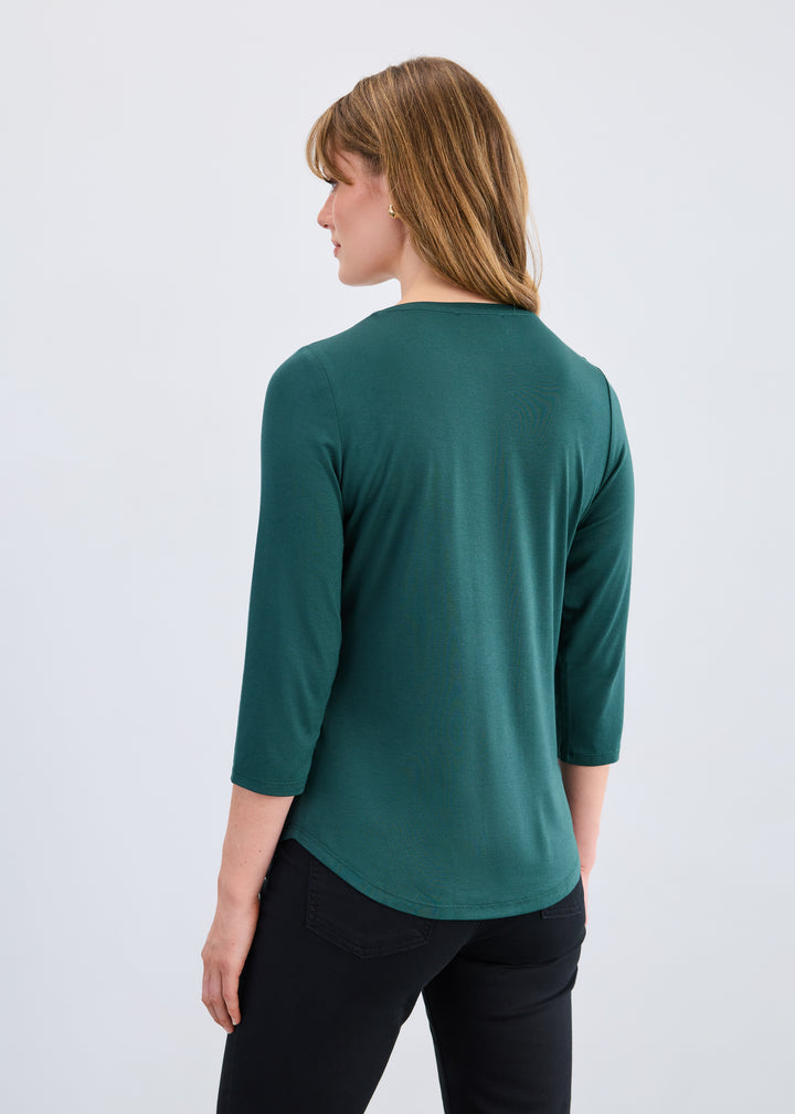 Woman wearing a green top with a white background