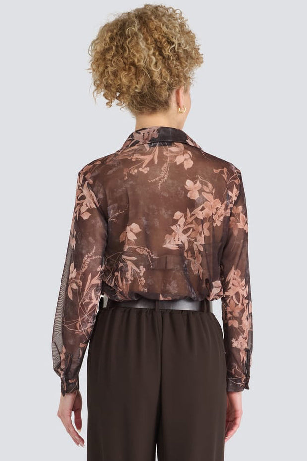 A model shown from the back wearing a sheer brown floral long-sleeve shirt and dark brown wide-leg trousers, set against a solid light gray background.