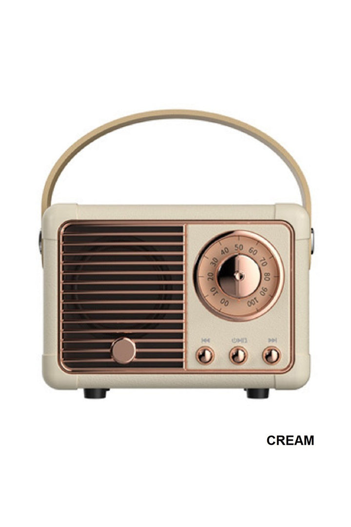 Vintage-style radio with cream and bronze design on a white background