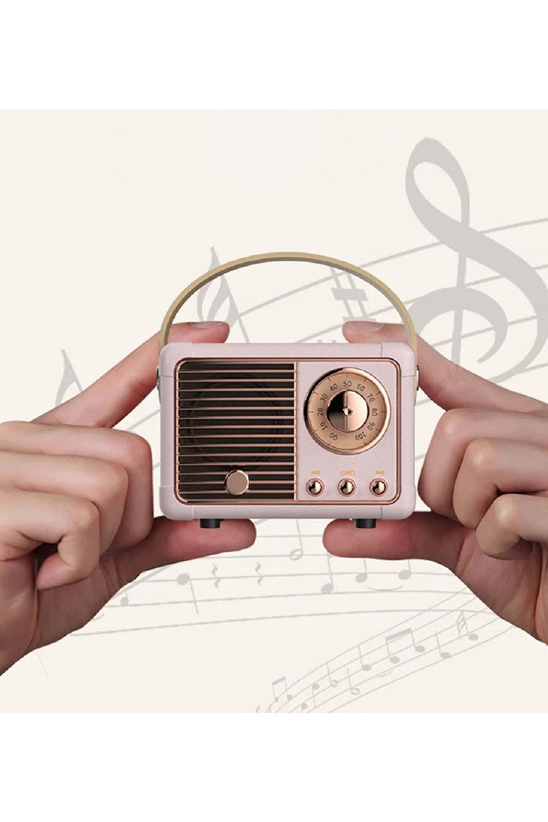 Small vintage-style radio held between two hands with a music sheet background