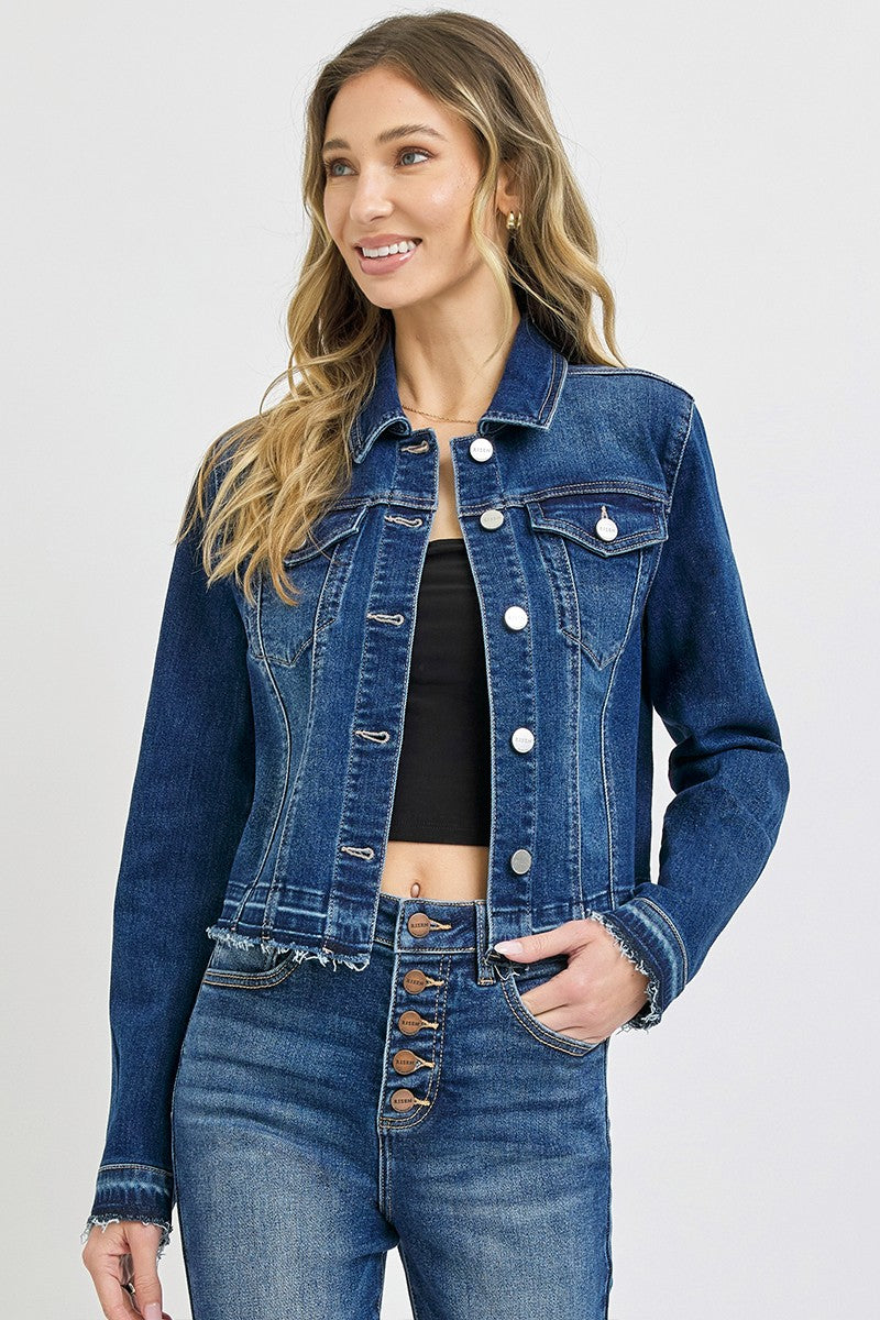 Woman wearing a blue denim jacket and jeans on a white background