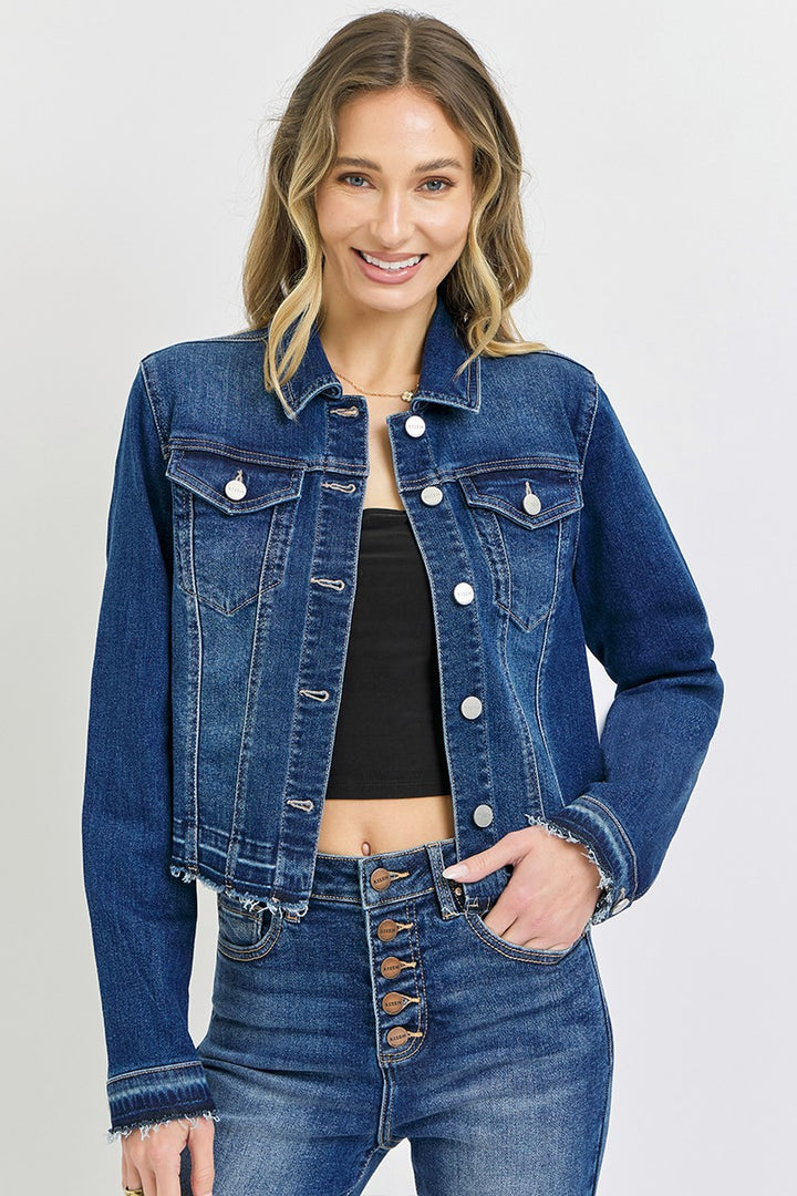Woman wearing a blue denim jacket and jeans on a white background