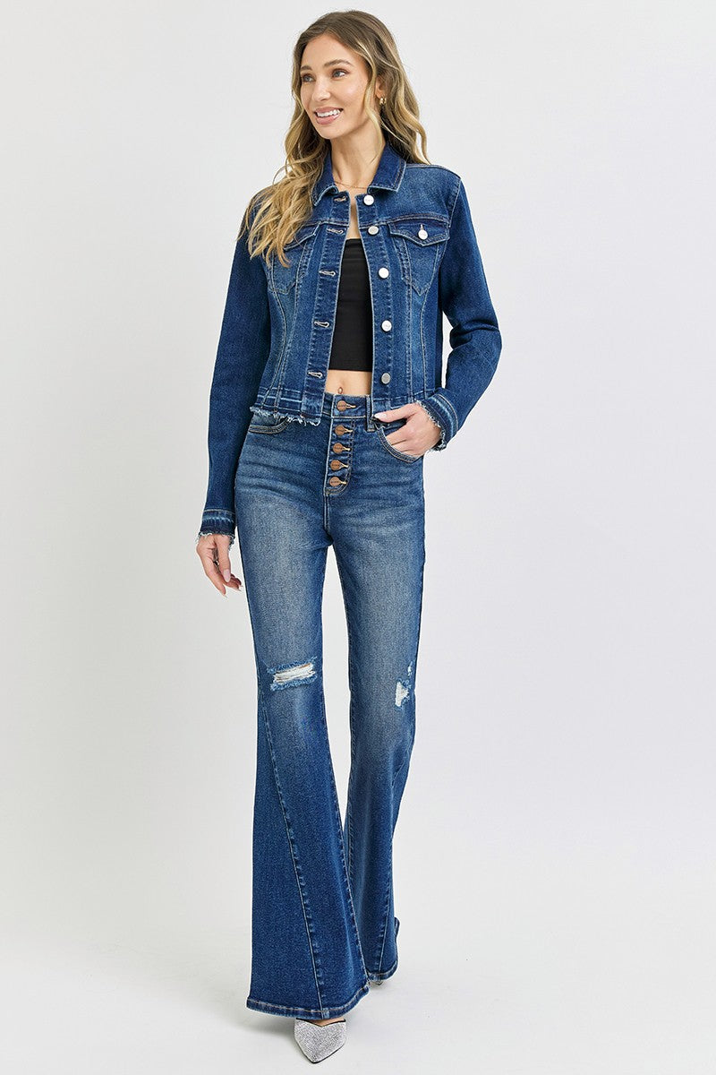 Woman wearing a blue denim jacket and jeans on a white background