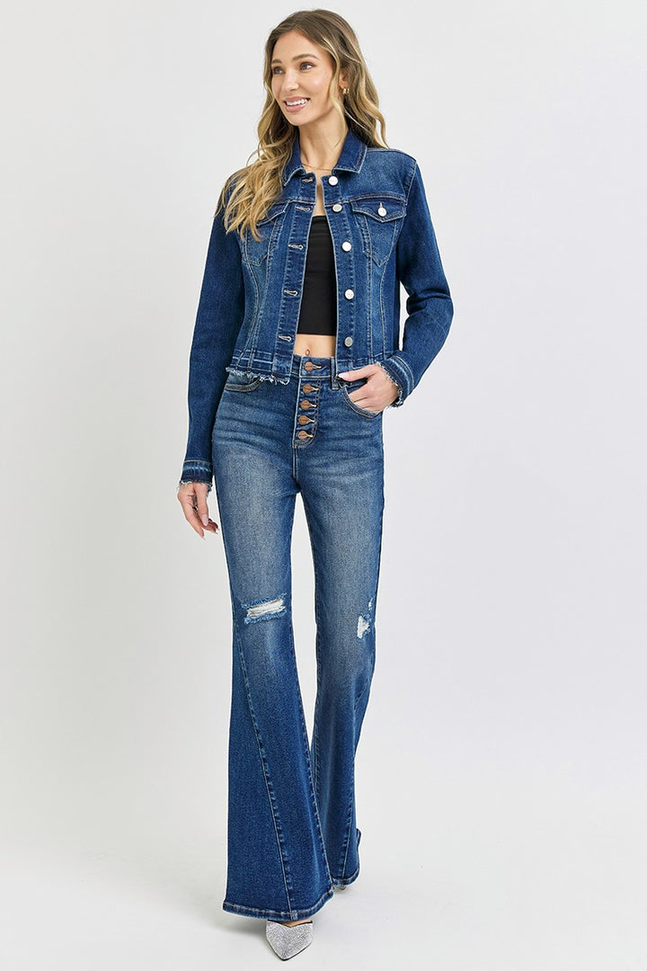 Woman wearing a blue denim jacket and jeans on a white background